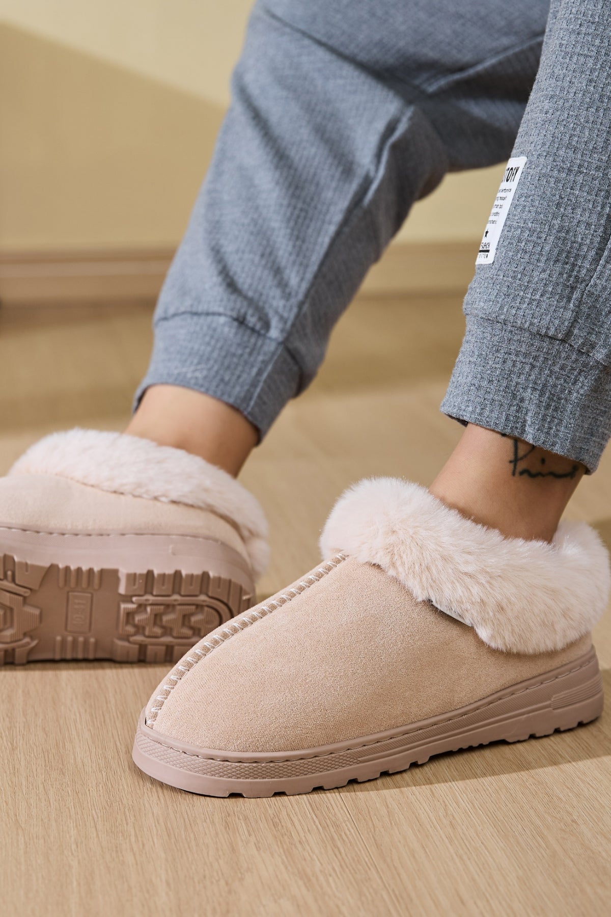 Woman wearing Faux Fur Round Toe Platform Slippers while enjoying a cozy, relaxed day at home.