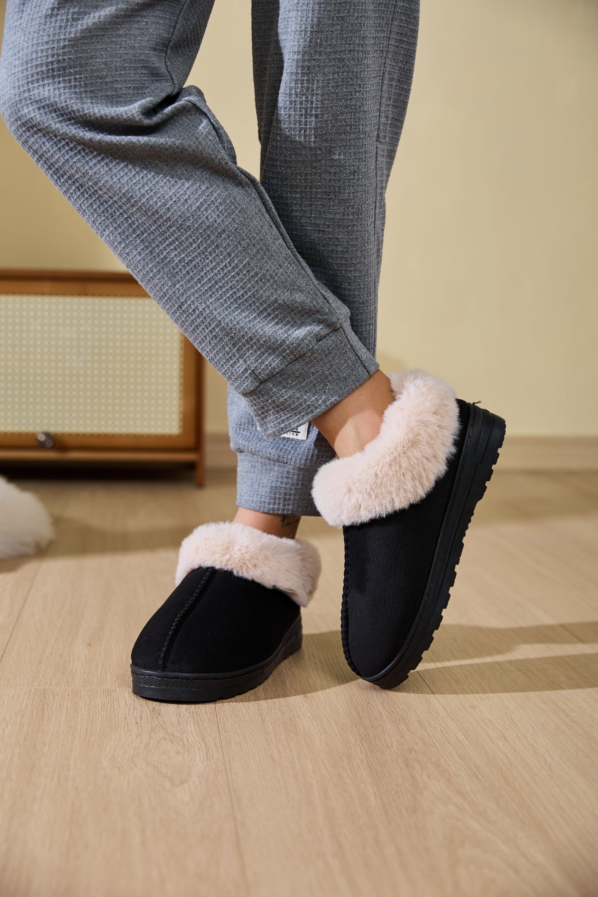 Model wearing Faux Fur Round Toe Platform Slippers with soft faux fur lining, styled for lounging at home.