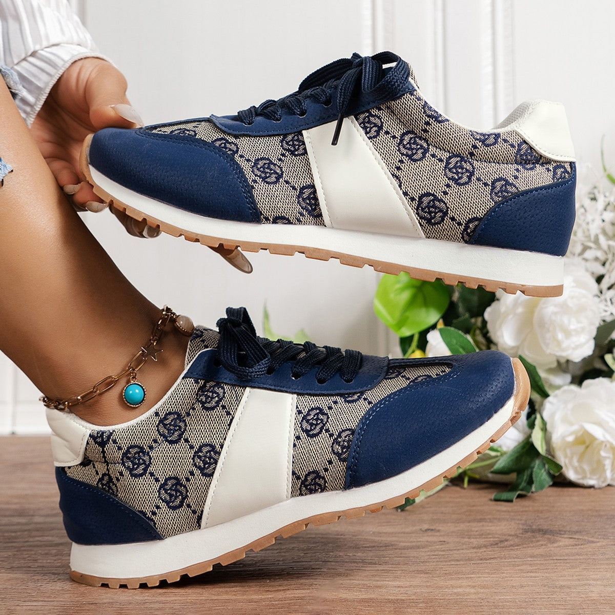 Pair of Floral Round Toe Flat Sneakers showcasing vibrant floral prints for a trendy, casual look.