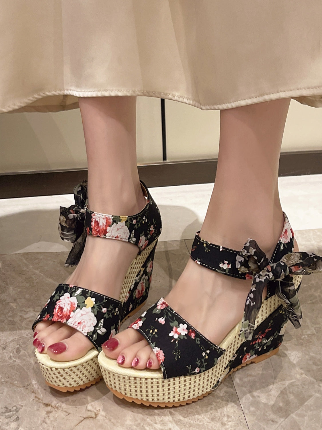 Foot wearing Floral Tied High Heel Sandals with a tied strap, showing off the floral design and high heel.