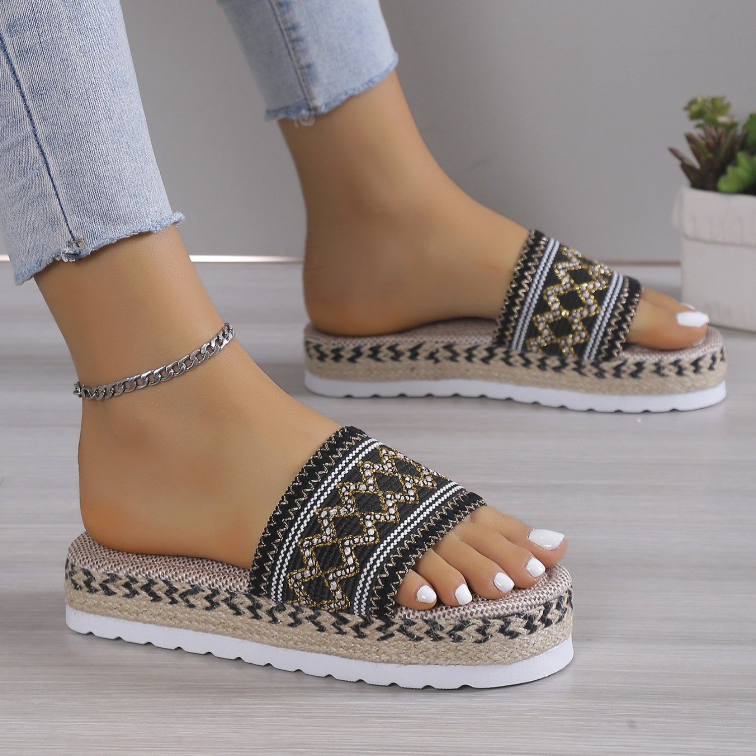 Foot wearing Geometric Weave Platform Sandals, styled with casual summer clothes for a relaxed look.