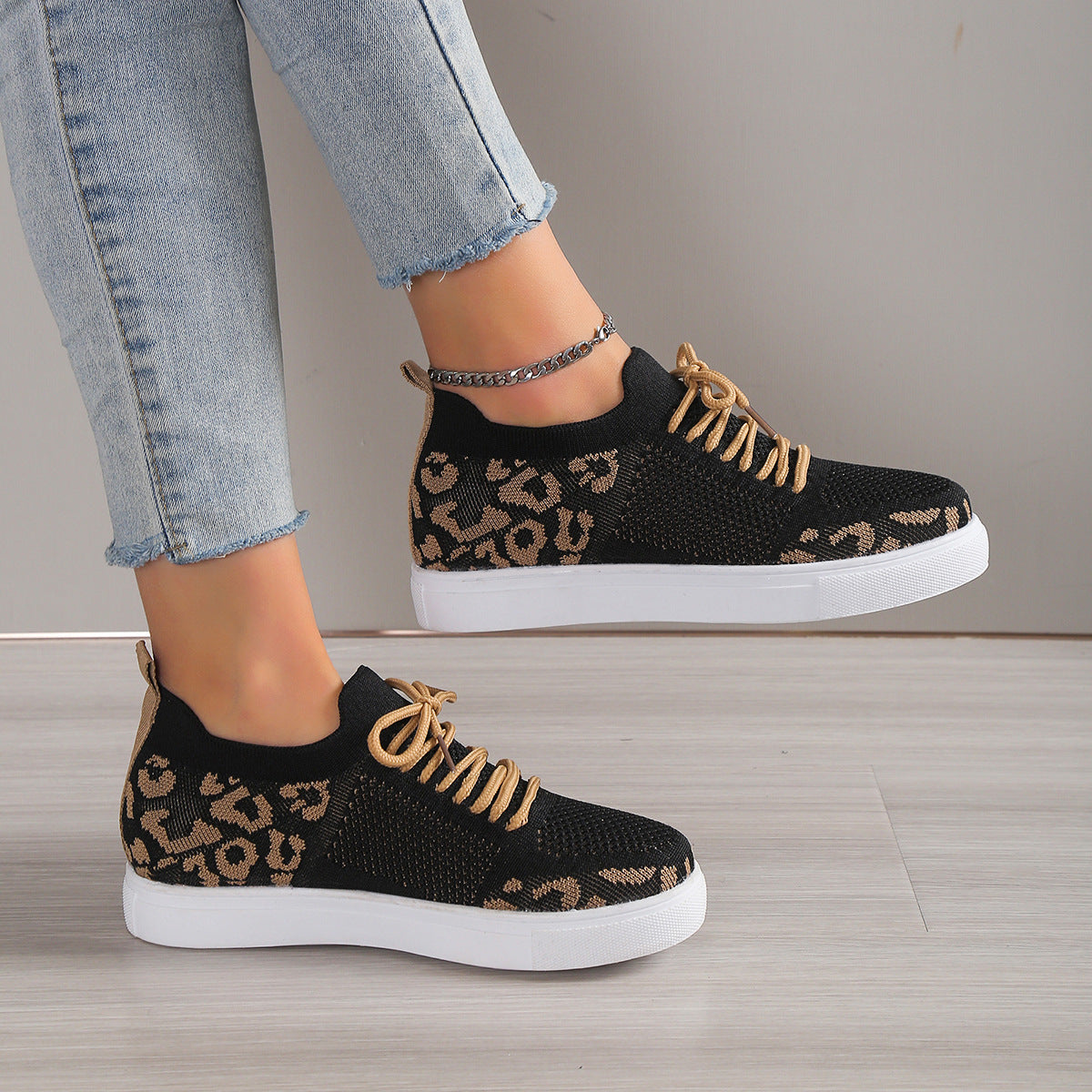 Model wearing Lace-Up Leopard Flat Sneakers, styled with casual denim and a t-shirt for a laid-back look.