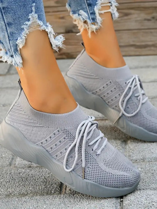 Model wearing Mesh Round Toe Flat Athletic Shoes in a casual setting, showcasing their sleek and sporty design.