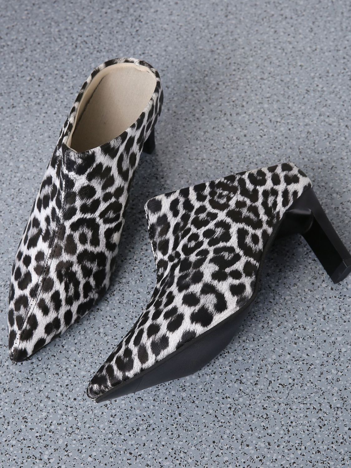 A pair of PU Leather Leopard Point Toe Pumps, designed to make a bold fashion statement.