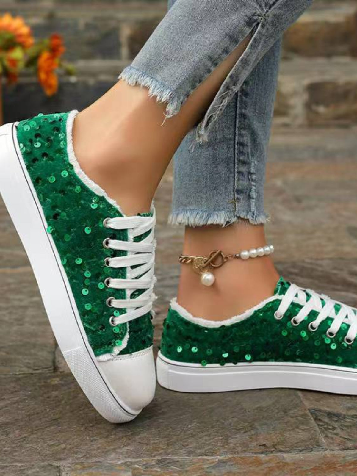 Sequin Round Toe Flat Sneakers placed on pavement, perfect for outdoor wear and casual outings.