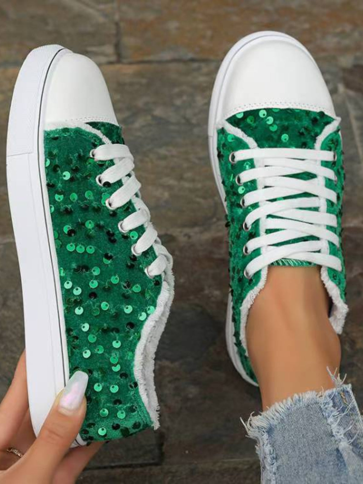 A pair of Sequin Round Toe Flat Sneakers laid on the floor, highlighting the sequin accents.